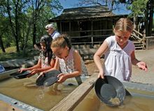 Columbia State Park, Sonora, California -- Young miners pan for gold to experience part of the gold rush era.