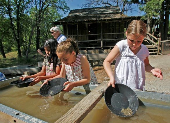 Columbia State Park, Sonora, California -- Young miners pan for gold to experience part of the gold rush era. Columbia State Park, Sonora, California -- Young miners pan for gold to experience part of the gold rush era.