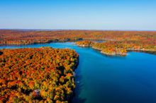Fall foliage surrounds Thumb Lake in Charlevoix County, Michigan