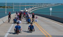 Wounded veterans and their supporters ride adaptive and regular bicycles near the top of the Florida Keys Overseas Highway’s iconic Seven Mile Bridge Friday, Jan. 9, 2026, near Marathon, Fla. Organized by the Wounded Warrior Project, the Soldier Ride brou